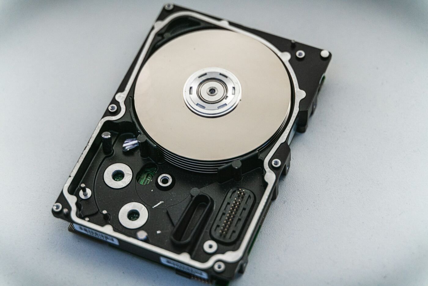 An opened hard drive showing its platter